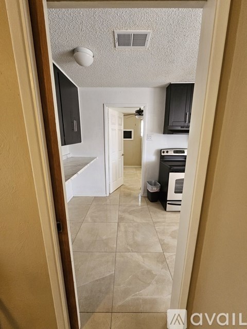 A kitchen with a white oven and black cabinets.