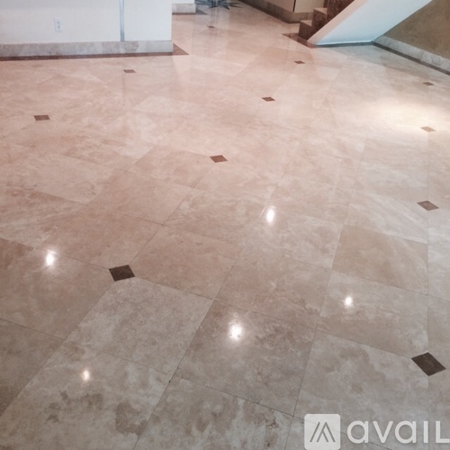 A marble floor with a pattern of squares and rectangles.