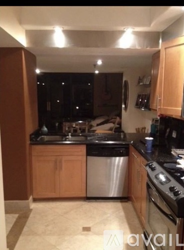 A kitchen with wooden cabinets and a black stove top.