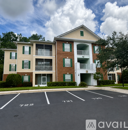 Apartment building with green shutters and a white garage door.