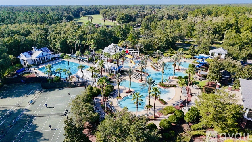 A large resort with a tennis court and two pools.