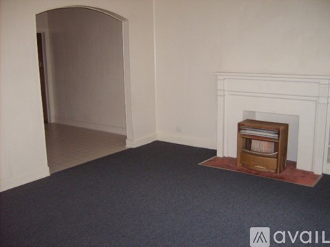 A room with a fireplace and a carpet.