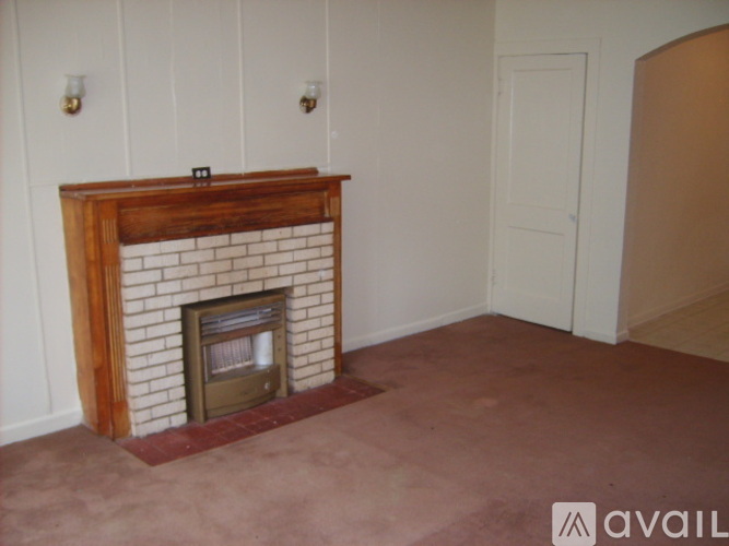 A room with a fireplace and a door.