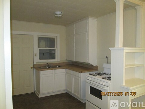 A room with a fireplace and a door.