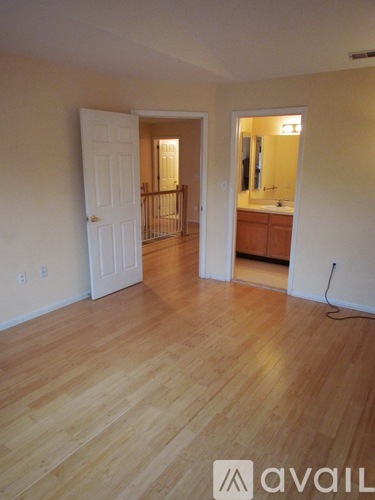 A room with wooden floors and a white door.