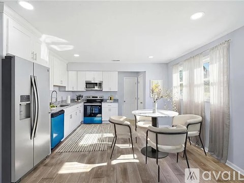 A modern kitchen with a dining table set for four.