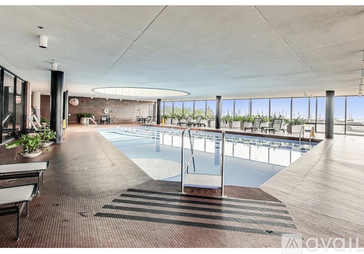 A large indoor swimming pool with a glass barrier divider.