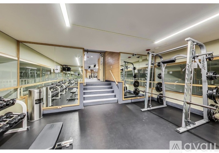 A well-equipped gym with a variety of machines and weights.