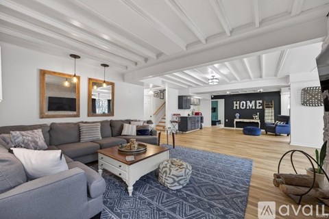 A living room with a grey couch and a coffee table.