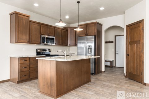 A kitchen with wooden cabinets and a white countertop.