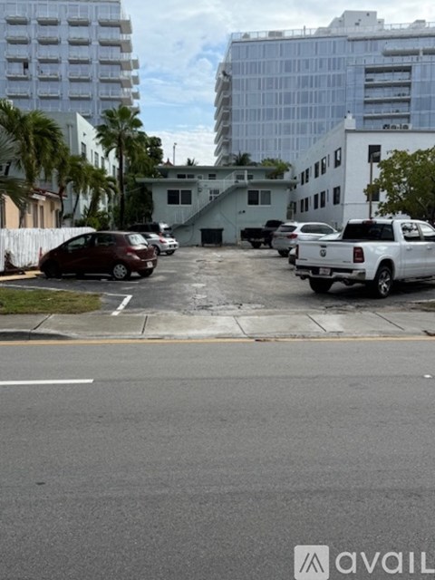 A parking lot with cars and buildings in the background.