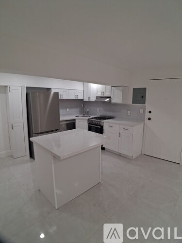A kitchen with white cabinets and appliances.