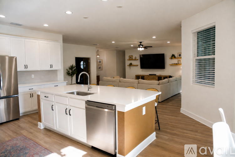 A modern kitchen with stainless steel appliances and white cabinets.