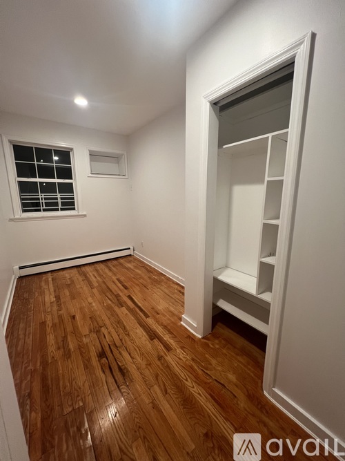 A room with wooden floors and a window.