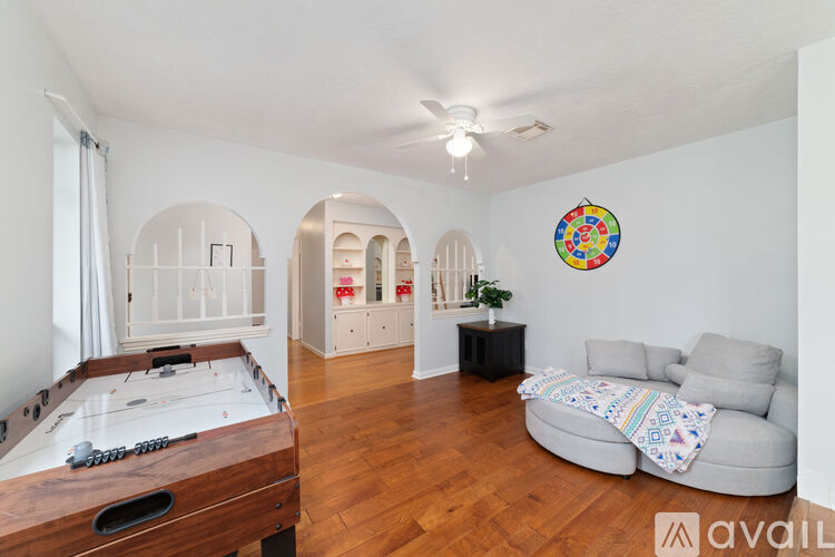 A room with a pool table and a couch.