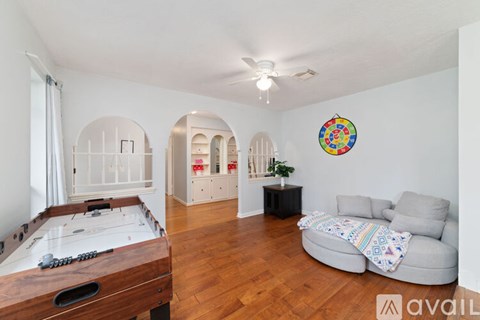 A room with a pool table and a couch.