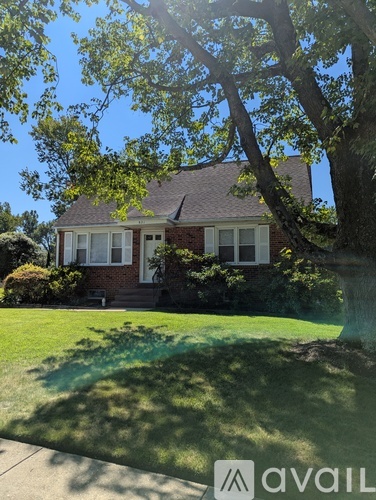A house with a tree in front of it.