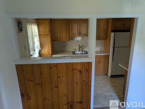 A kitchen with wooden cabinets and a white countertop.