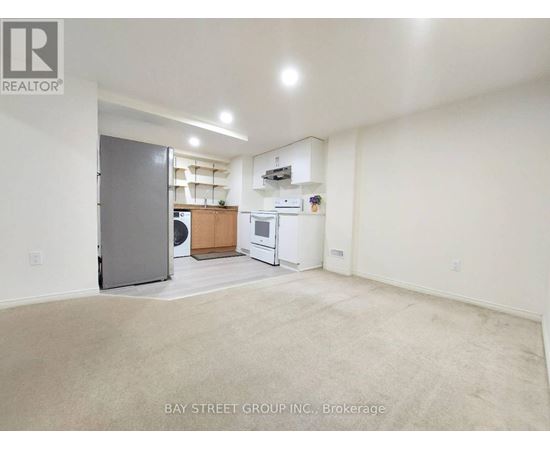 A spacious room with a washer and dryer in it.