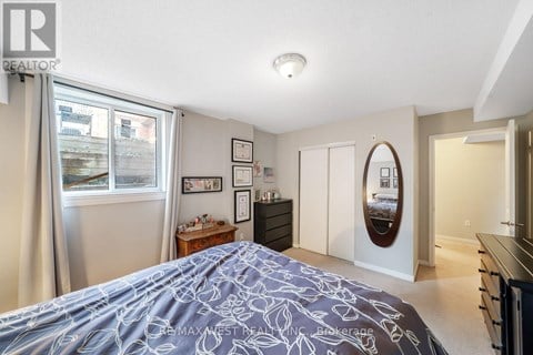 A bedroom with a large bed and a mirror on the wall.