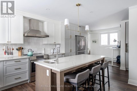 A kitchen with a table and chairs in the middle of it.