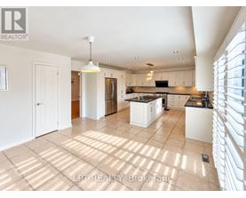 A spacious kitchen with white cabinets and a large island.