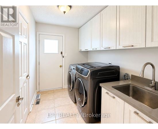 A small laundry room with a washer and dryer.