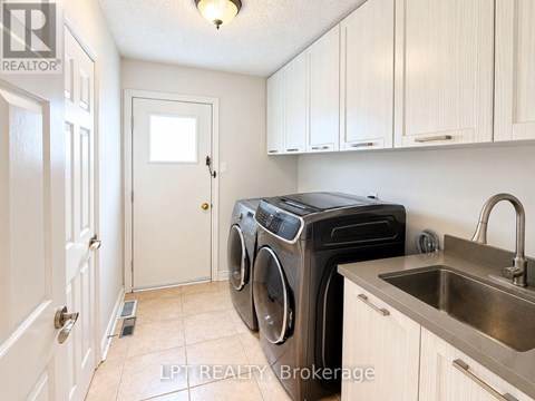 A small laundry room with a washer and dryer.