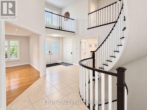 A spacious interior of a house with a curved staircase.