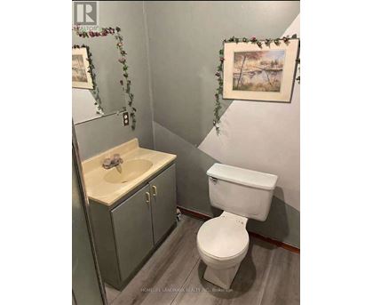 A white toilet sits next to a sink in a bathroom.