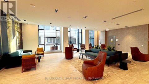 A spacious waiting area with wooden floors and a variety of seating options.