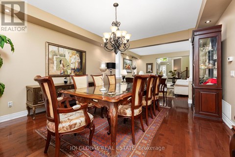 A dining room with a wooden table and chairs.