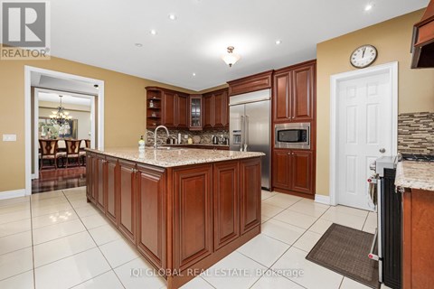 A kitchen with brown cabinets and a granite countertop.