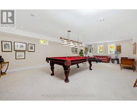 A room with a pool table and a red couch.