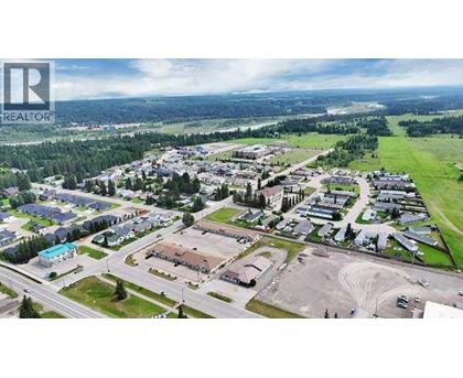 A bird's eye view of a residential area with a large open space in the foreground.
