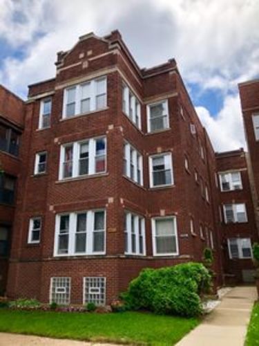A red brick building with white trim and windows.
