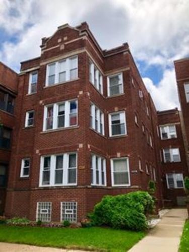 A red brick building with white trim and windows.