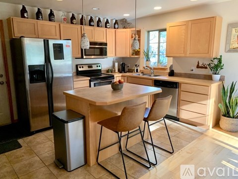 A kitchen with a table and chairs in the middle of it.