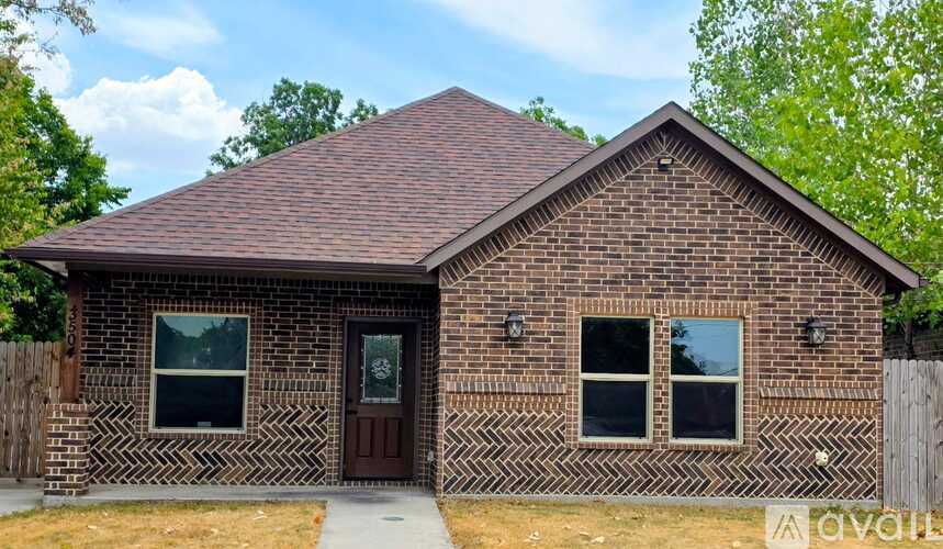 A small house with a brown door and windows.
