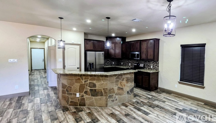 A kitchen with a stone island in the middle of the room.