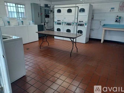 A room with a table and a washing machine.