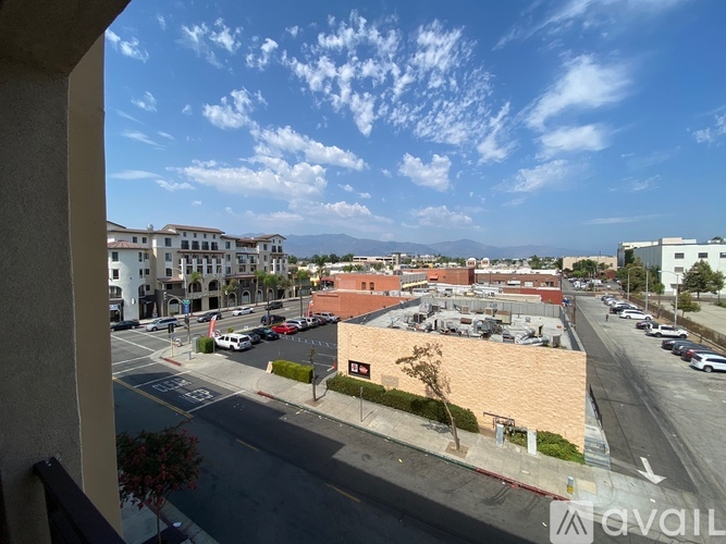 A view from a window of a street with cars and buildings.