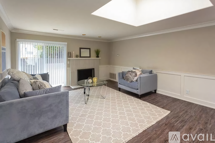 A living room with a grey couch, a coffee table, and a fireplace.