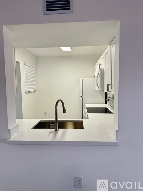 A kitchen with a sink and a window.