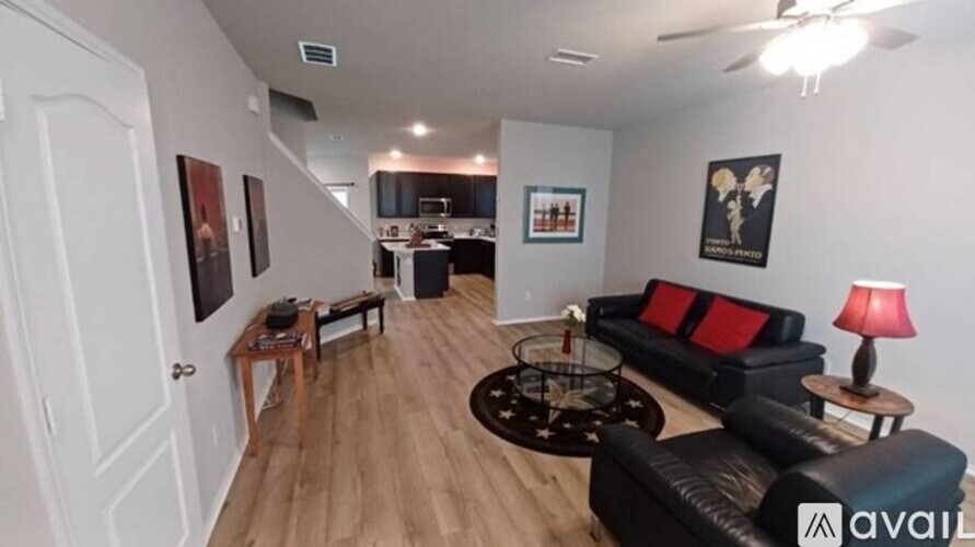 A living room with a black couch and a coffee table.