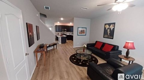 A living room with a black couch and a coffee table.