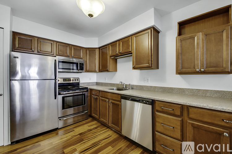 A kitchen with wooden cabinets and stainless steel appliances.