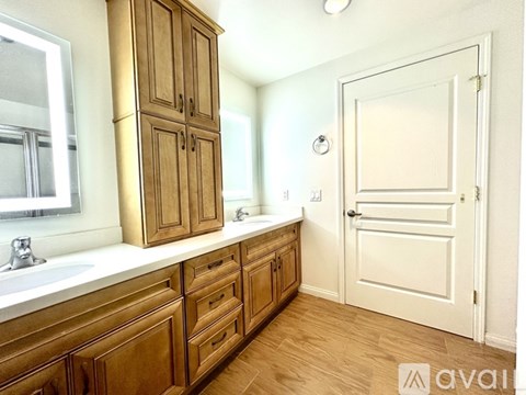 A kitchen with wooden cabinets and a white door.