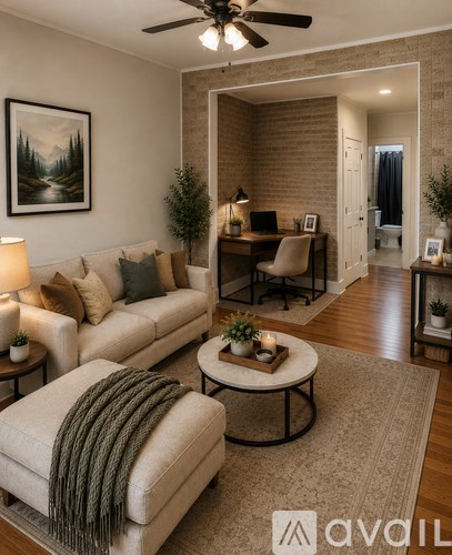 A living room with a couch, a chair, a coffee table, and a painting on the wall.