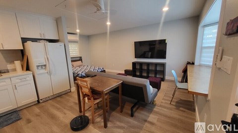 A kitchen with white cabinets and a wooden table.
